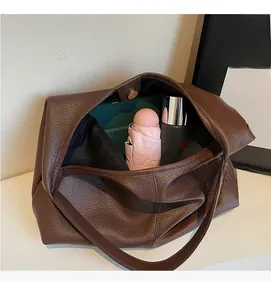 Detail of spacious dark brown leather tote interior showing daily storage capacity