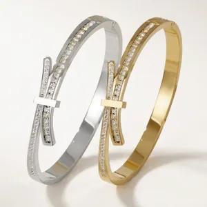 Minimalist T-shaped stainless steel bow cuff bracelet with cubic zirconia in gold and silver