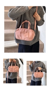 Detail of pink matte Boston bag showing silver hardware and detachable crossbody strap
