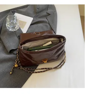 Detail view of brown quilted bag interior showing spacious capacity and golden chain strap
