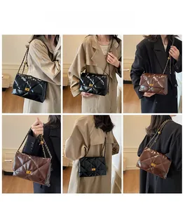 Detail of adjustable gold chain straps and turn-lock on quilted faux leather bags