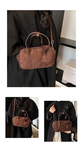 Detail of vintage dark brown suede boston bag with reinforced stitching and top handles