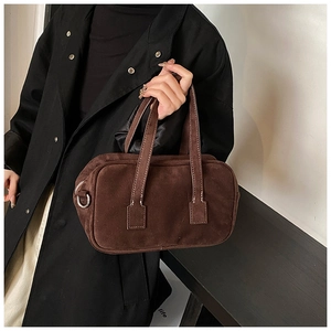 Detail of dark brown frosted suede boston bag with metal D-rings and sturdy top handles