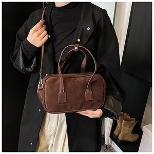 Close-up of deep brown matte suede texture on a vintage Boston bag with silver hardware