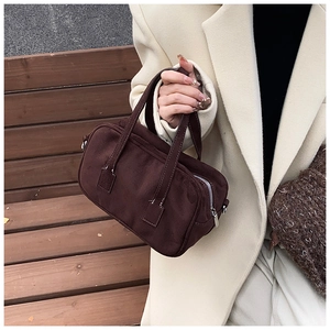 Close-up of vintage brown matte Boston bag with silver zipper and refined stitching
