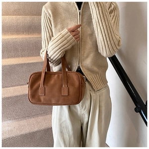 Detailed view of vintage brown frosted texture Boston bag with soft matte suede finish