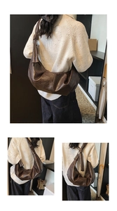 Detailed view of dark brown soft leather pleated shoulder bag with spacious interior