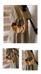 Detail of light brown crescent croissant bag with soft pleated PU leather texture