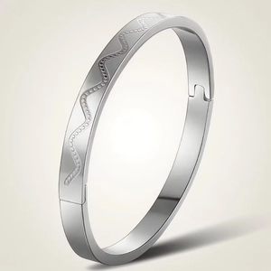 Detail view of silver stainless steel wave bangle with white sparkling rhinestones