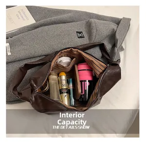 Detail showing high-capacity interior of dark brown slouchy hobo bag with zip pocket