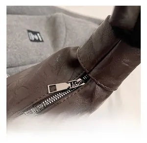Detailed macro view of high-quality silver metal zipper on dark brown faux leather bag