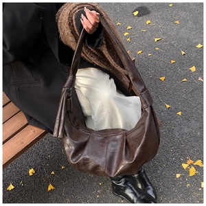 Close-up of a large dark brown crescent hobo bag featuring premium faux leather texture