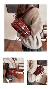 Macro detail of dark red glossy leather shoulder bag with vintage tassel and pocket design