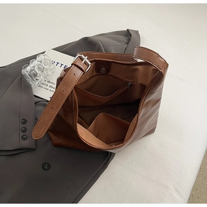 Interior view of large brown tote bag showing magnetic clasp and zippered pocket