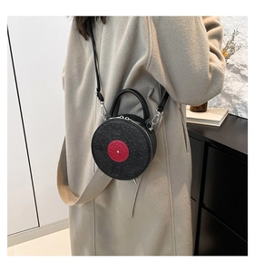 Detail of round vintage vinyl record bag with embossed leather texture on beige coat