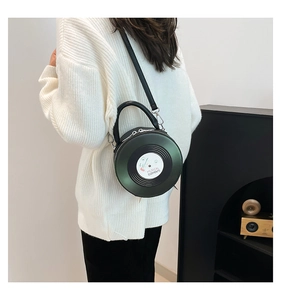 Detail of retro vinyl record handbag in metallic green with Musical Elements logo print