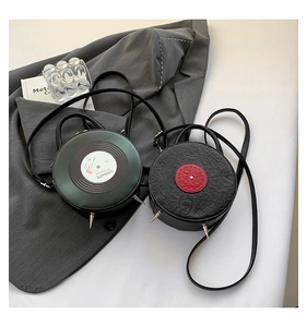 Detail of round vinyl record bags with silver punk studs and unique musical textures