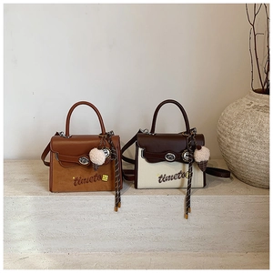 Detail of vintage tote bags with 'timeto' embroidery and plush ice cream charms