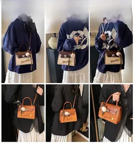 Detail view of retro tote bag in brown leather and canvas with ice cream charm