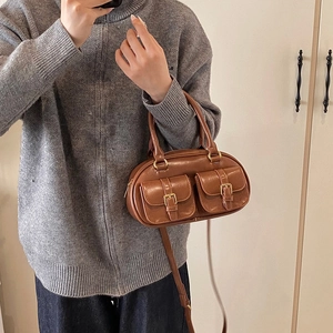 Vintage dark brown bowling bag with gold buckles and adjustable strap for winter fashion