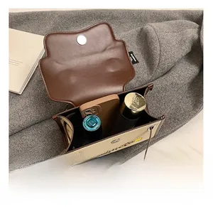 Detail shot of the interior capacity showing daily items in the brown leather and canvas bag