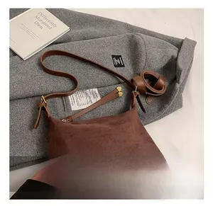 Detail view of brown faux suede tote bag with adjustable strap and large capacity