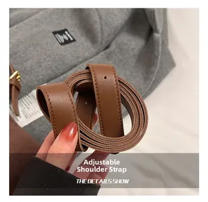 Detail shot of the dark brown lychee texture leather adjustable shoulder strap