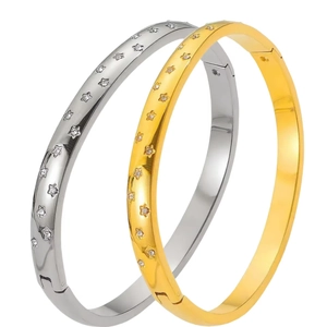 Set of two stainless steel star engraved bangles in gold and silver finish with crystals