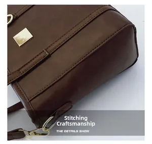Detailed close-up of double-stitched seams and gold hardware on dark brown bucket bag