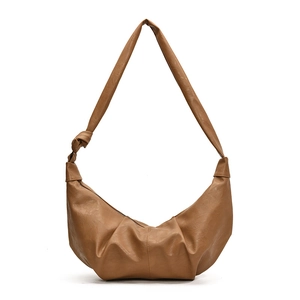 Brown croissant shoulder bag with pleated texture and stylish knotted strap for women