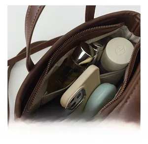 Top view of dark brown leather handbag interior showing organized pockets and storage capacity