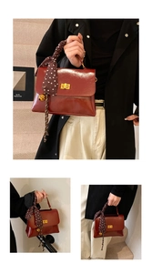 Detail of dark red crossbody bag with golden twist lock and polka dot scarf handle