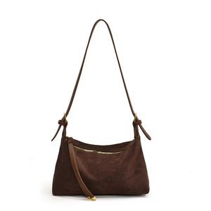 Retro dark brown suede tote bag with golden zipper and adjustable strap on white background