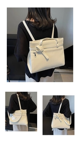Rear view of cream multi-functional backpack showing leather strap accents and zipper detail