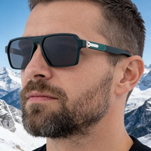 Close-up of matte dark green square sunglasses featuring textured temple details