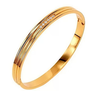 Polished gold stainless steel open bangle with parallel lines and inlaid crystals