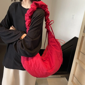 Red quilted puffer dumpling shoulder bag with large ruffles and padded waterproof fabric