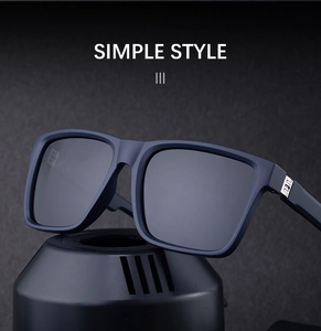 Detail view of matte navy square sunglasses with silver metal hinge and polarized lens