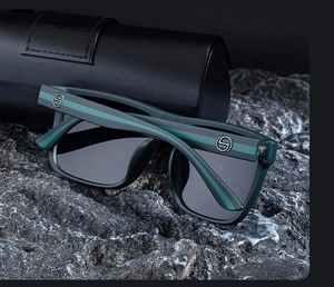 Detail of square polarized sunglasses with metallic S logo on the temple and leather case