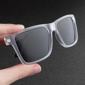 Detail of matte gray polarized square sunglasses showing metal hinge and frame texture