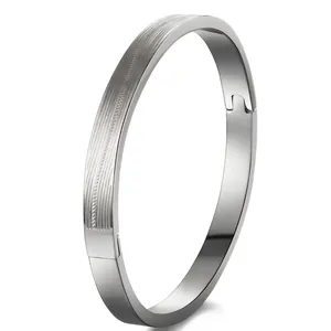 Detail of silver stainless steel bangle showing brushed and mirror polished finish