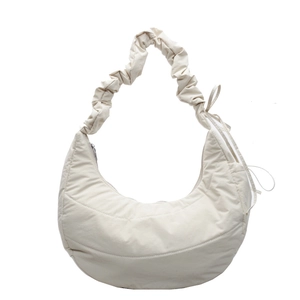Minimalist cream white quilted dumpling bag with ruffled strap and side bow detail