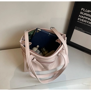 Detail view of pink leather tote bag showing spacious interior with tablet and phone