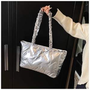 Detail of silver metallic quilted tote bag with unique ruched cloud handle strap