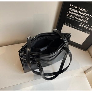 Internal structure of the large black tote bag showing three main compartments and silver hardware