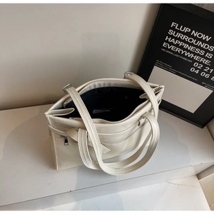 Spacious beige faux leather tote bag interior with zipper pocket and black lining