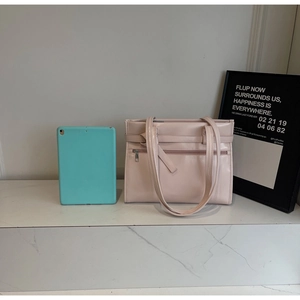 Pink faux leather tote bag detail with tablet inside showing large storage capacity