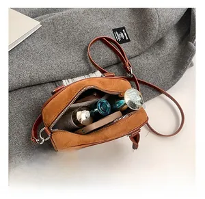 Vue détaillée de l'intérieur du sac en daim marron montrant sa grande capacité de rangement