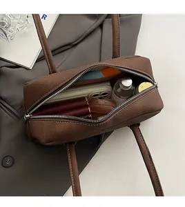 Interior view of brown pebble leather bowling bag showing ample space for essentials