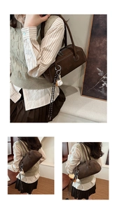 Detail of a brown matte bowling bag with a baseball tassel charm and logo embossing